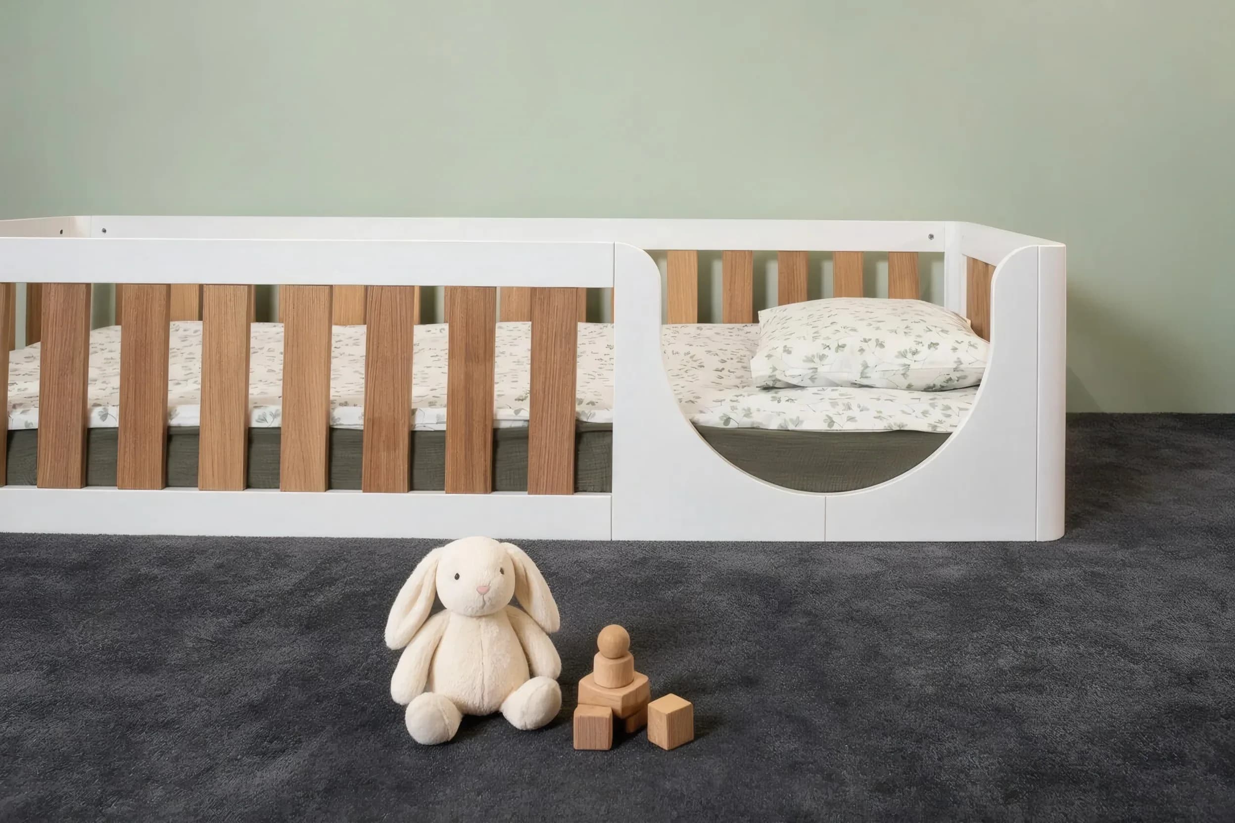 White floor bed with oak veneer bars and rounded opening, front view
