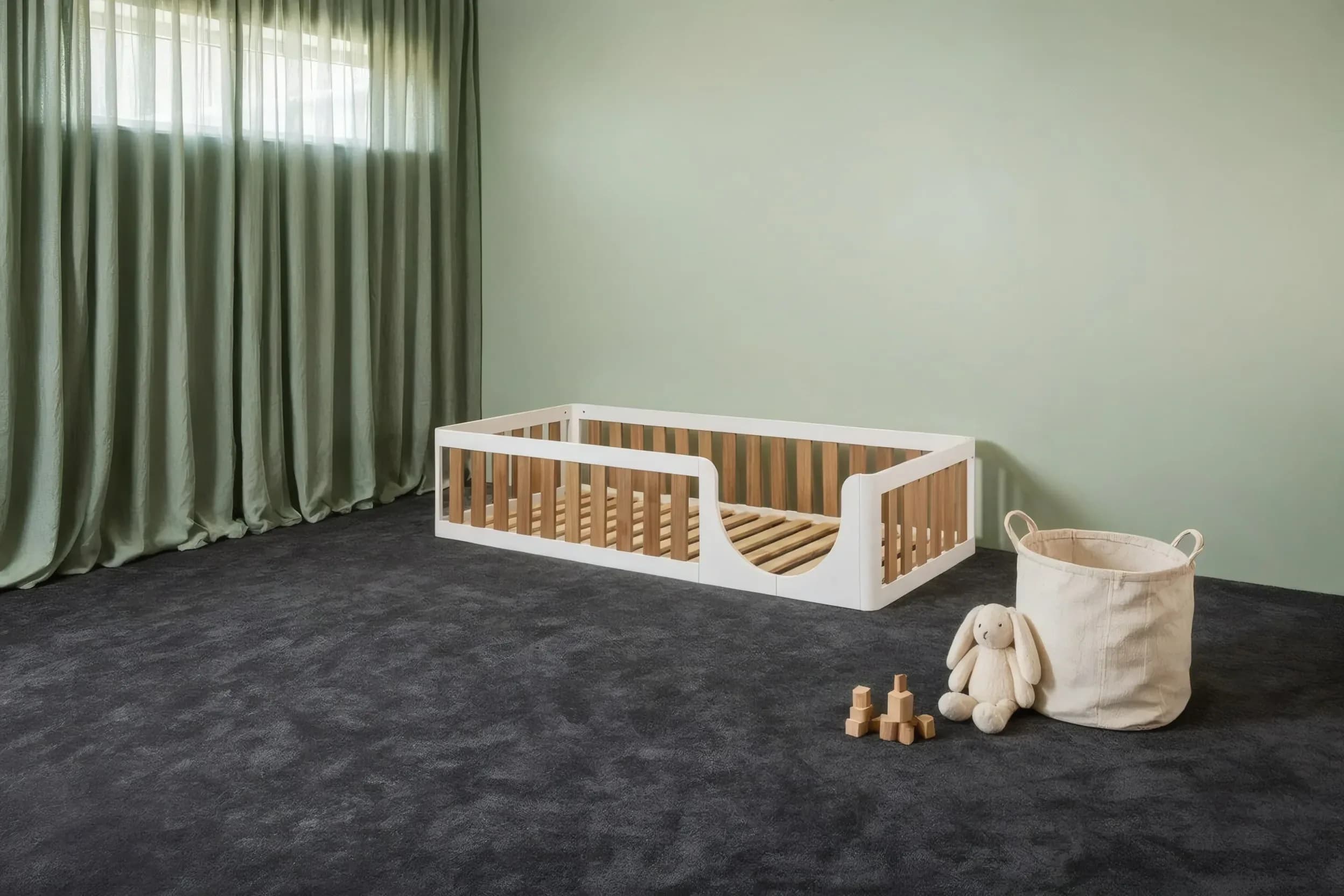 Two-tone floor bed in a nursery by the window, angled view