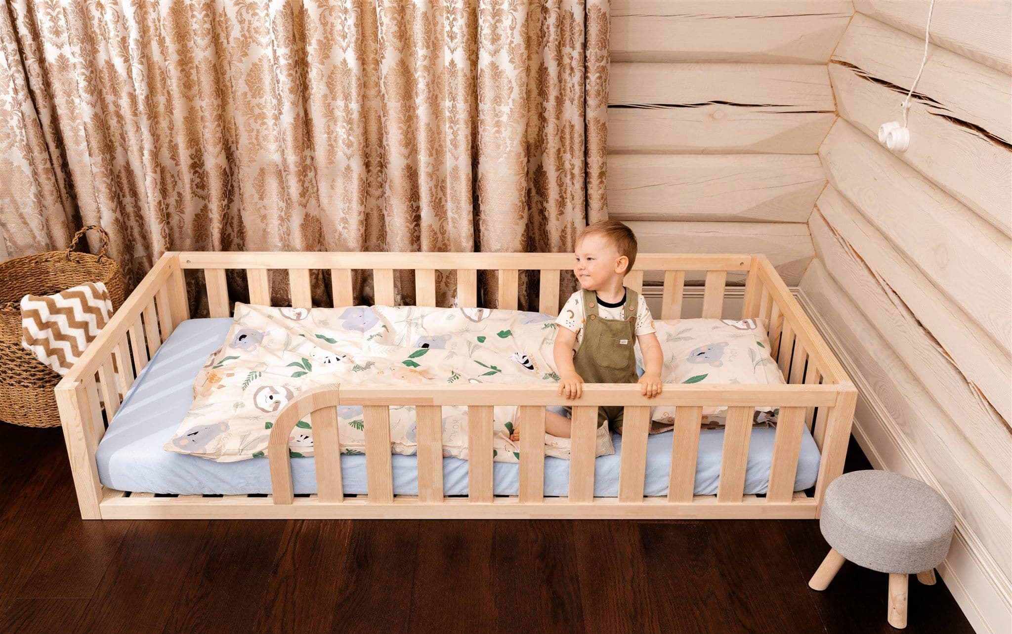 Lit de sol Montessori en bois naturel avec entrée arrondie et bords de protection pour la chambre d'enfant
